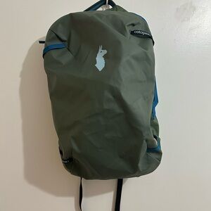 Cotopaxi Allpa 35L Travel Pack in an olive green colorway with blue accents